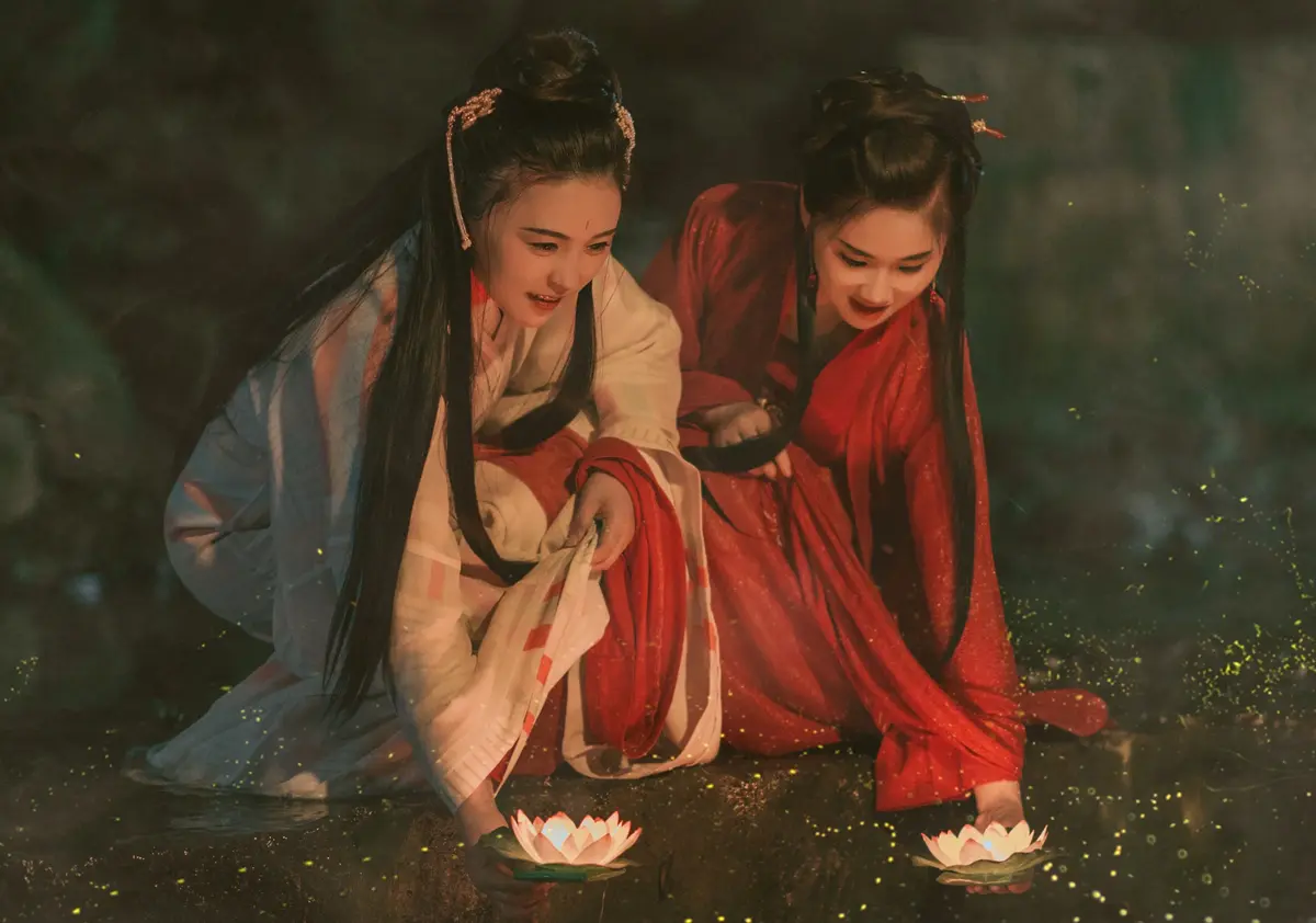 A photo of beautiful Chinese women holding lotus flowers.