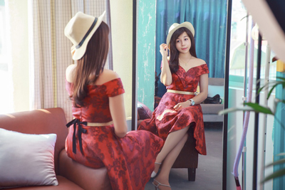 A Chinese woman looking at herself in the mirror.