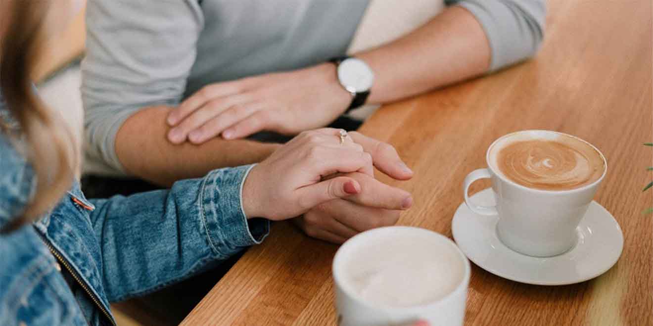 A photo of a man and a woman holding hands