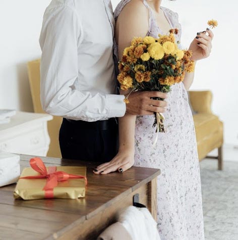 Man giving woman flowers.